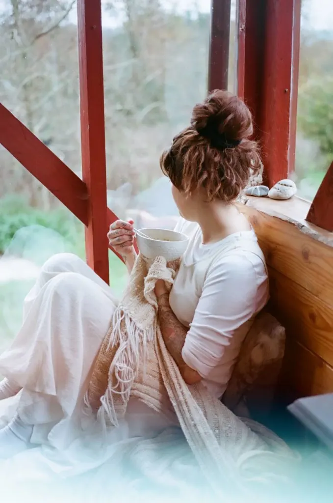 mindful eating woman in bed gazing out window